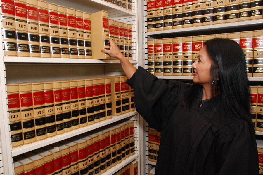 Photo of administrative law judge with law books