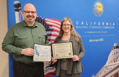 Kevin and Laura holding their certificates