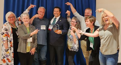 CBSC staff celebrate Enrique's award