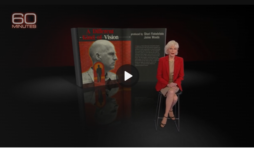 60 Minute snapshot of a woman sitting in the chair with a book open of a man's head and some words about the interview