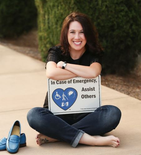 Tiffany Allen sitting criss cross on sidewalk