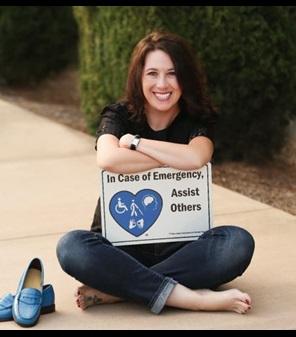Tiffany Allen sitting criss cross on sidewalk