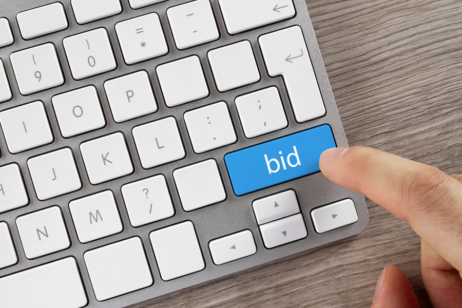 Picture of a keyboard with a blue bid button