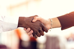 Image of Two people shaking hands