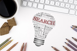 image of lite bulb with word SEARCH on it shrounded by pencils and cup of coffee