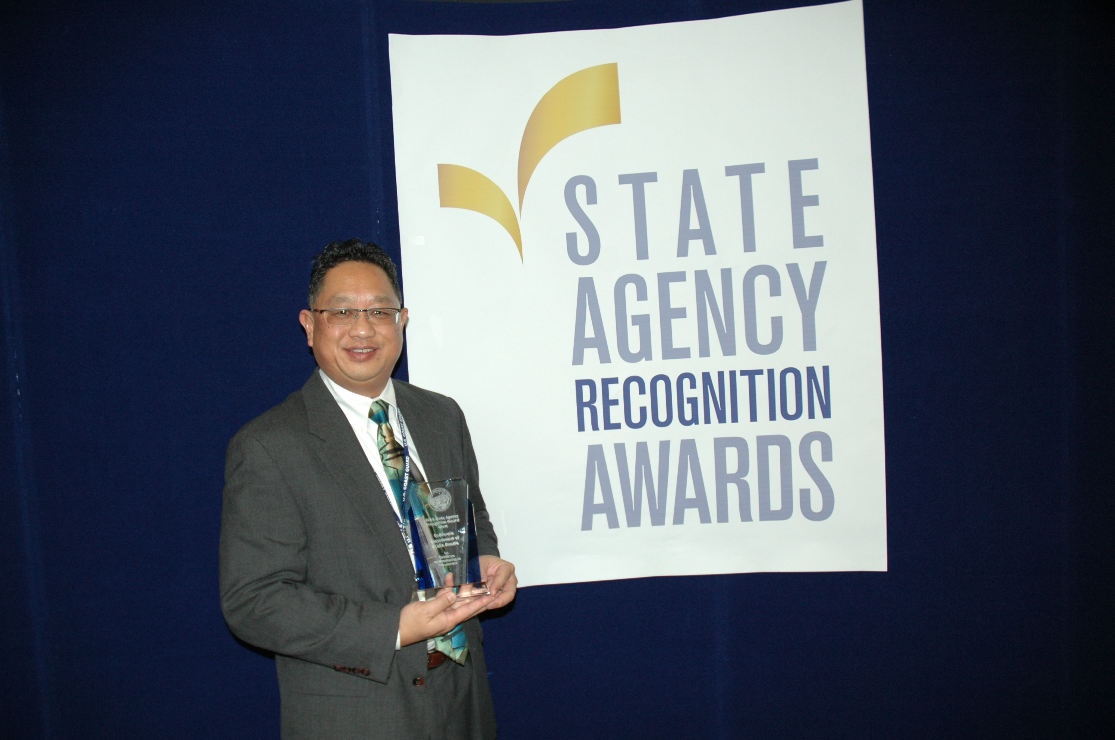 Alan Lum accepts the Silver SARA award for the California Department of public health