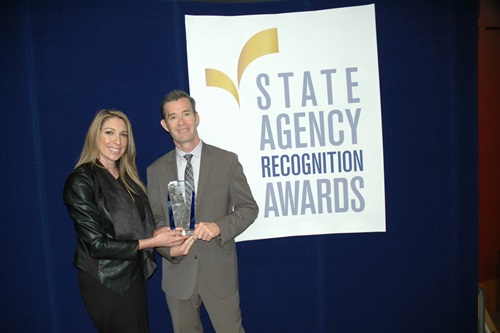 Jamie Jones and Keith Boylan accept the Gold SARA award for the California department of veterans affairs