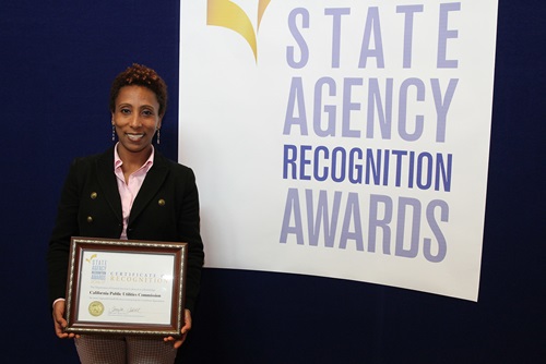 Bezawit Dilgassa accepts the most improved small business participation award for the California Public Utilities Commission for the medium agency category.