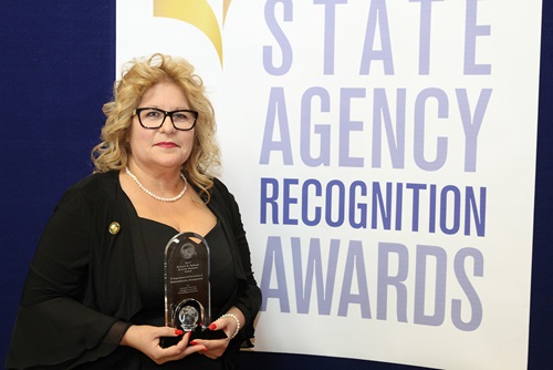 Nina Martinez accepts the Richard G. Polanco Diversity Outreach Award for the Department of Corrections and Rehabilitation, headquarters