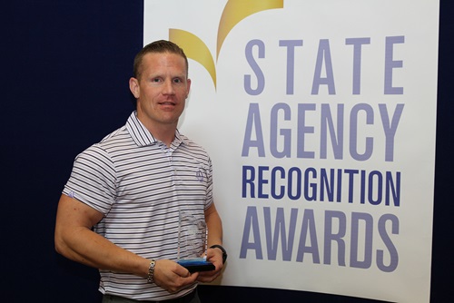 Ryan Nelson, California Department of Corrections and Rehabilitation, Folsom State Prison, accepts the Bronze Advocate of the Year award.