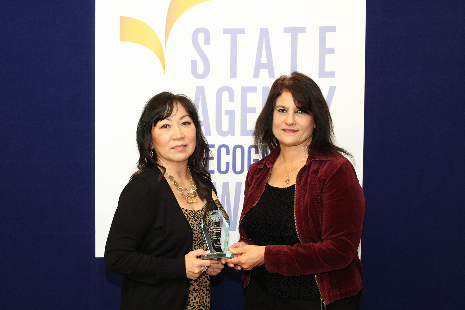 Theresa Snider and Kayla Dann accept the Bronze Agency of the Year Award for the Department of Public Health.
