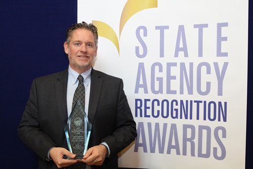 Tony Favro accepts the Gold agency of the year award for the Department of Forestry and Fire Protection