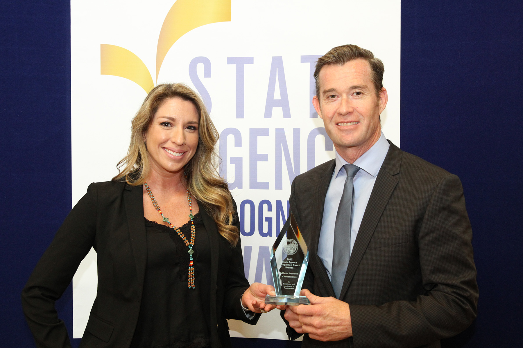 Jaime Jones and Keith Boylan accept the Bronze Agency of the Year award for the California Department of Veterans Affairs