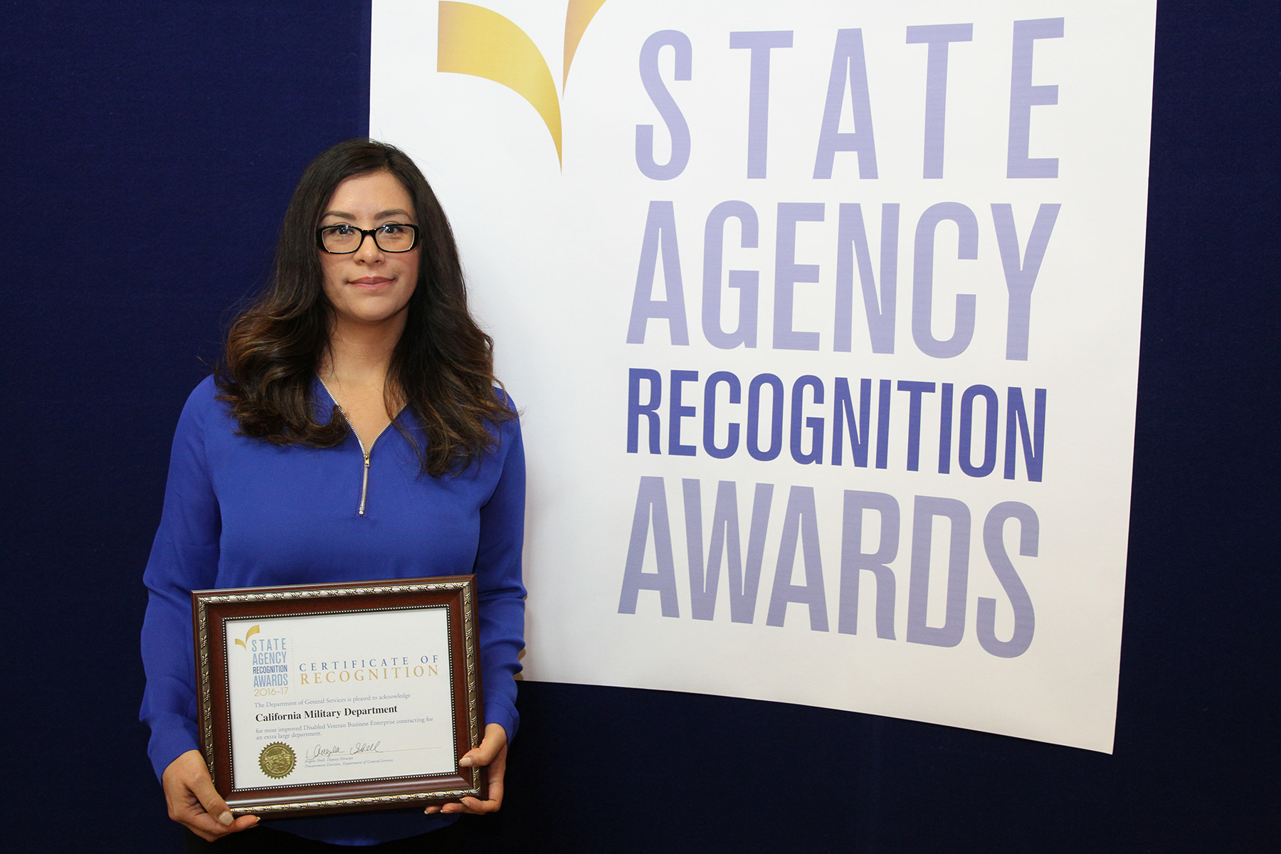 Sandy Villalobos accepts the most improved DVBE participation award for the California Military Department for the extra large agency category