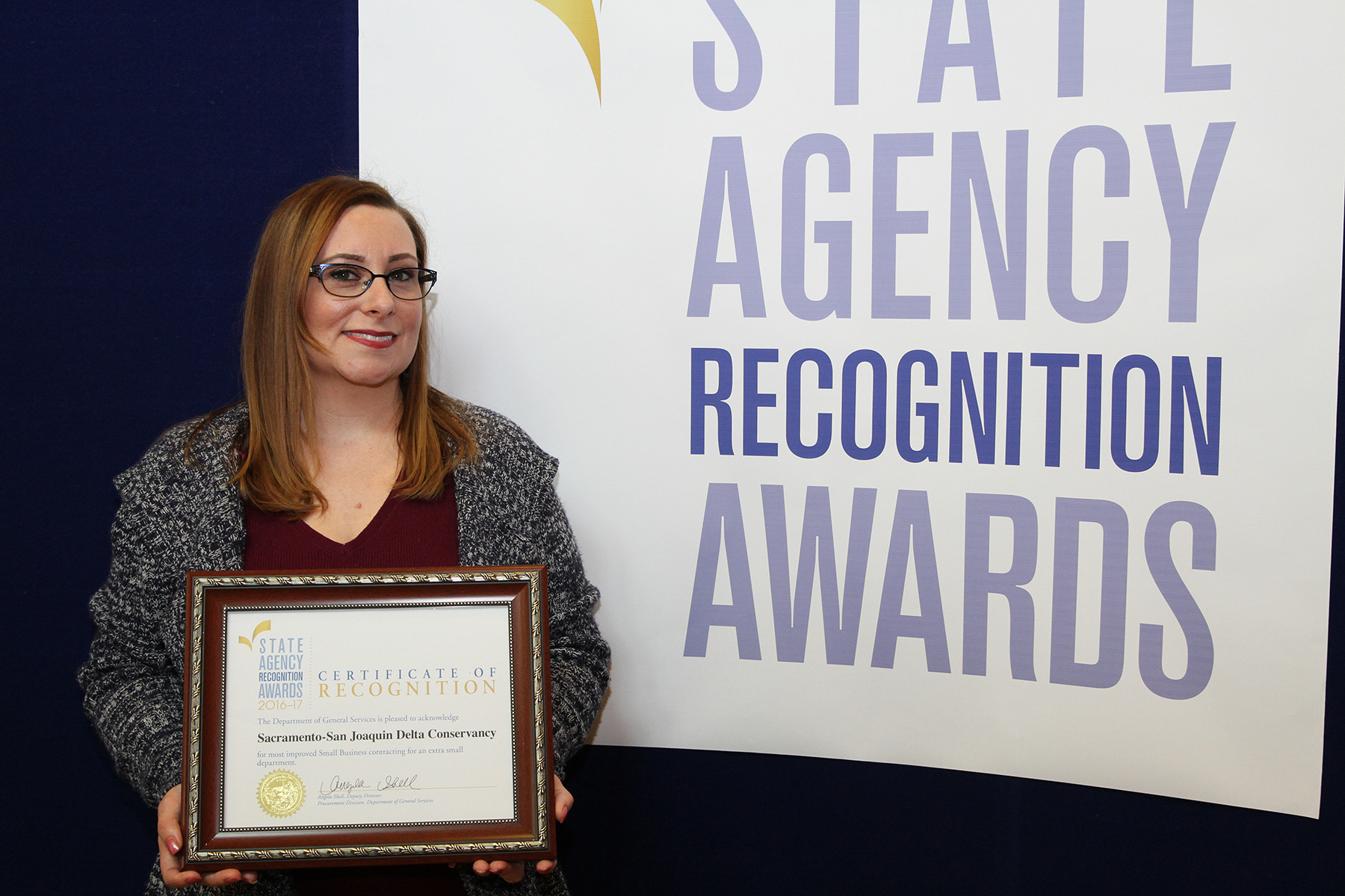 Sara Ward accepts the most improved small business participation award for the Sacramento-San Joaquin Delta Conservancy for the extra small agency category