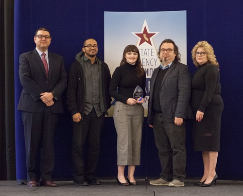 The Franchise Tax Board accepts the Bronze agency of the year award.