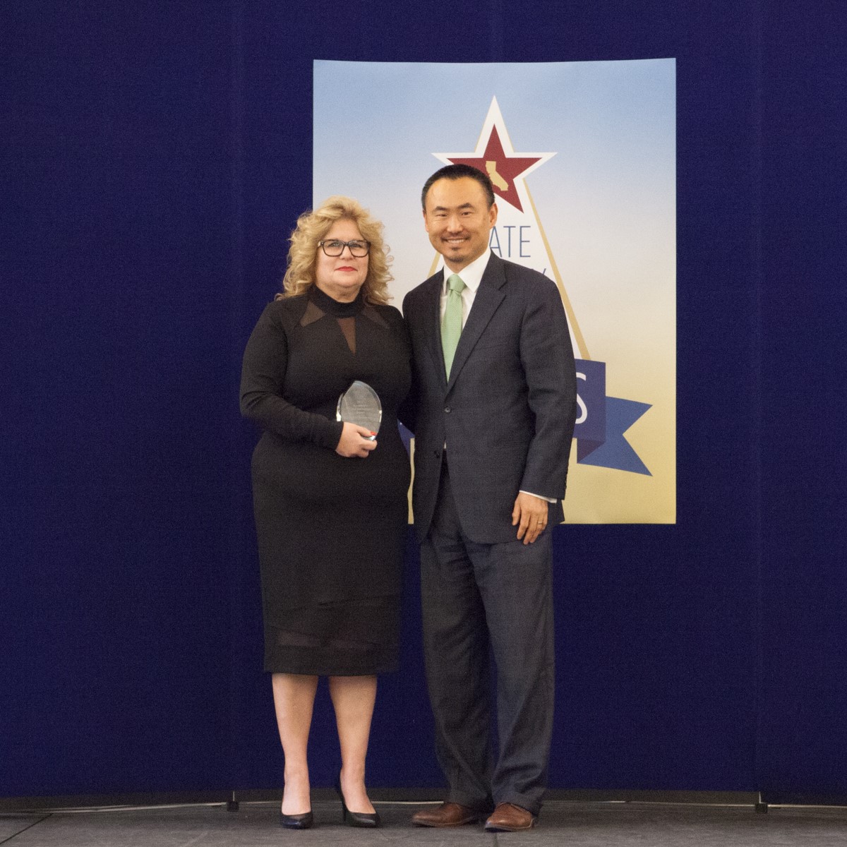 Nina Martinez accepts the Secretary's special achievement award, Presented by Daniel Kim, Director, Department of General Services