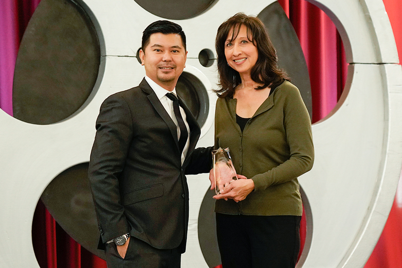 Darvin Manuel, Department of General Services, presents Yolanda Flores, Department of Corrections and Rehabilitation - North Kern State Prison, with the Gold Advocate of the Year Award.