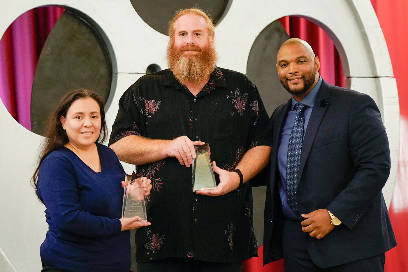 Jermaine Carter-Gibson, Department of General Services, presents Lauren Boehnke and Mike Fairbanks, Department of Corrections and Rehabilitation - California Institution for Men, with the Silver Advocate of the Year Award.