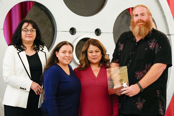 Anda Draghici, Department of General Services, presents the Department of Corrections and Rehabilitation - California Institution for Men with the Bronze Agency of the Year award.