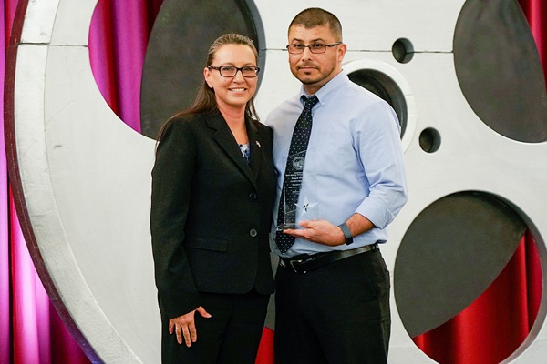 Angela Shell, Deputy Director of the Procurement Division and Chief Procurement Officer at the Department of General Services, presents Ramon Carlos, Department of Veterans Affairs, with the Angel Carrera Leadership Award.