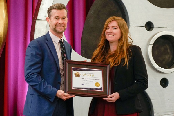 Keith Boylan, Department of Veterans Affairs, present the Debt Limit Allocation Committee with the award for Most Improved DVBE Contracting for an extra small agency.
