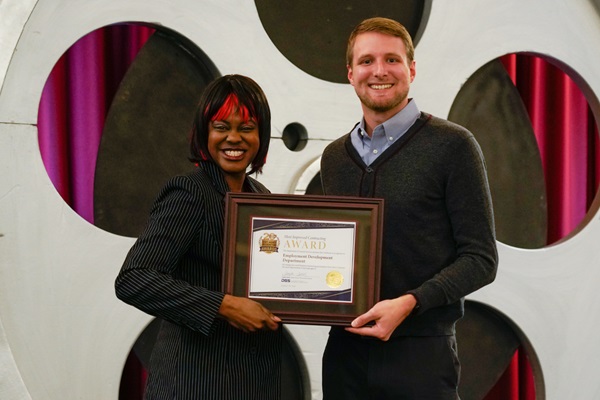 Demeshia Swanson, Department of General Services, presents the Employment Development Department with the award for Most Improved Small Business Contracting for a large agency.