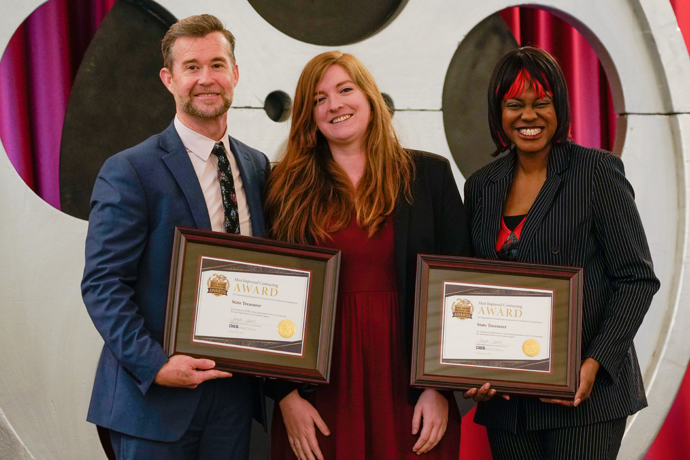 Keith Boylan, Department of Veterans Affairs, and Demeshia Swanson, Department of General Services, present the State Treasurer with the award for Most Improved Small Business Contracting and Most Improved DVBE Contracting for a medium agency.