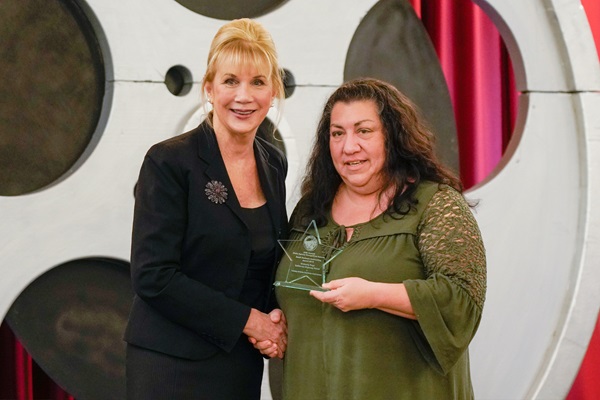 Nancy Huth, Department of General Services, presents Kimberly Page, California Highway Patrol, with the Small Business Contracting Award.