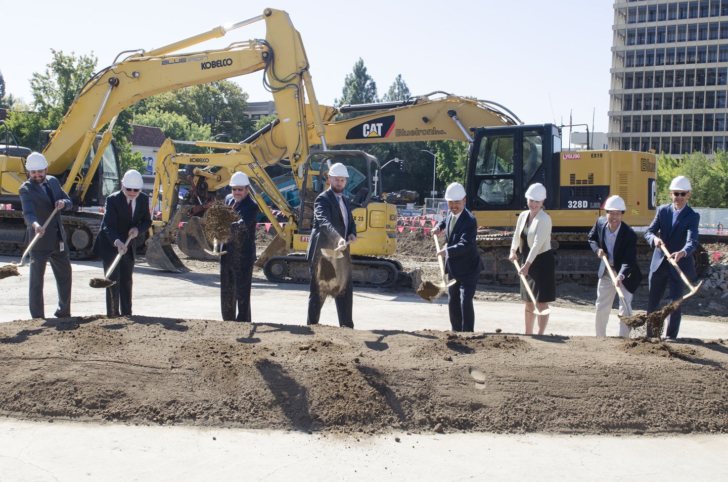 Officials move dirt at groundbreaking event
